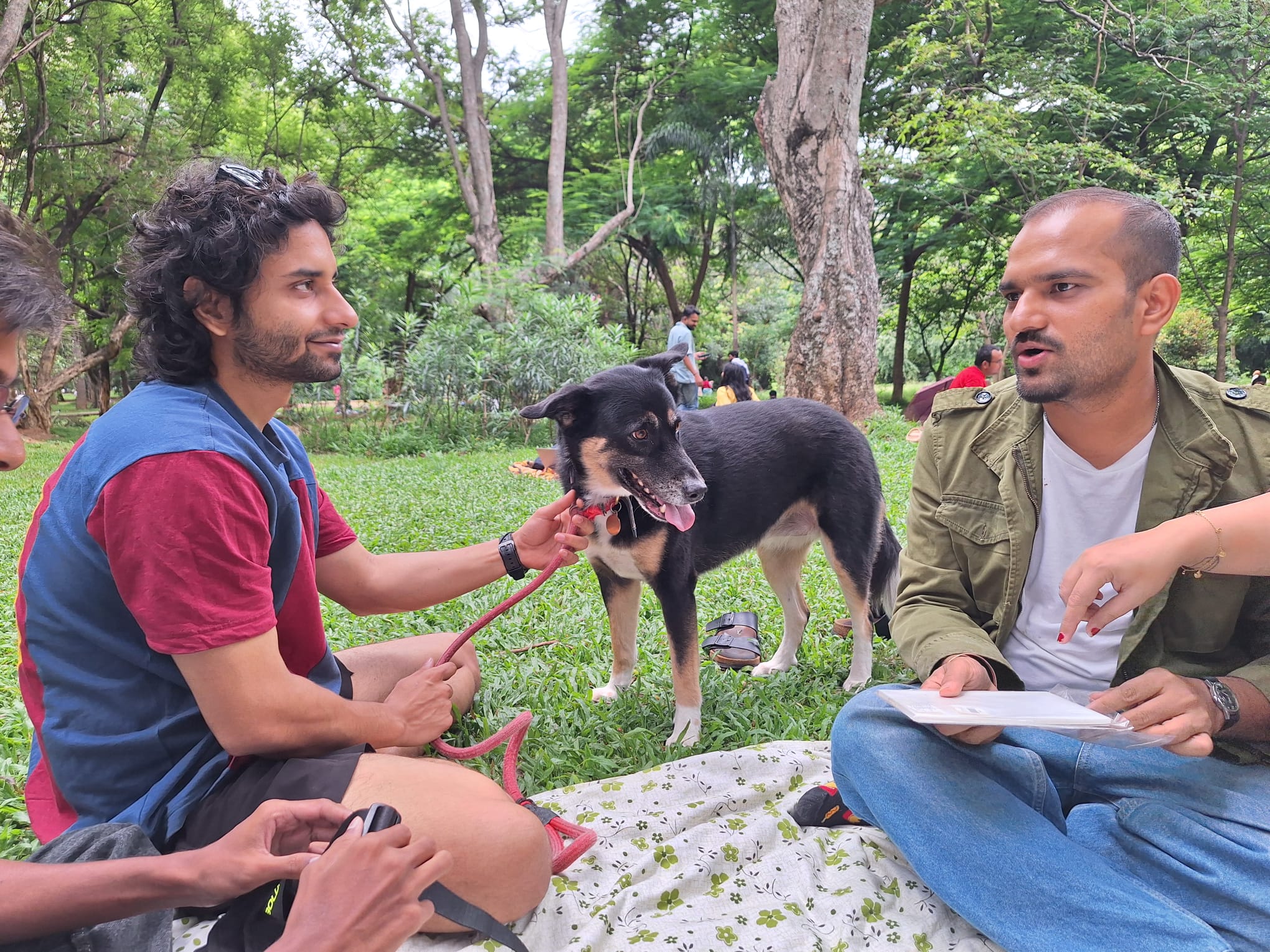 Aayush with a dog and friends in a park