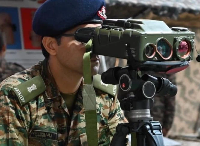 Optical sensor operator observing a distant area